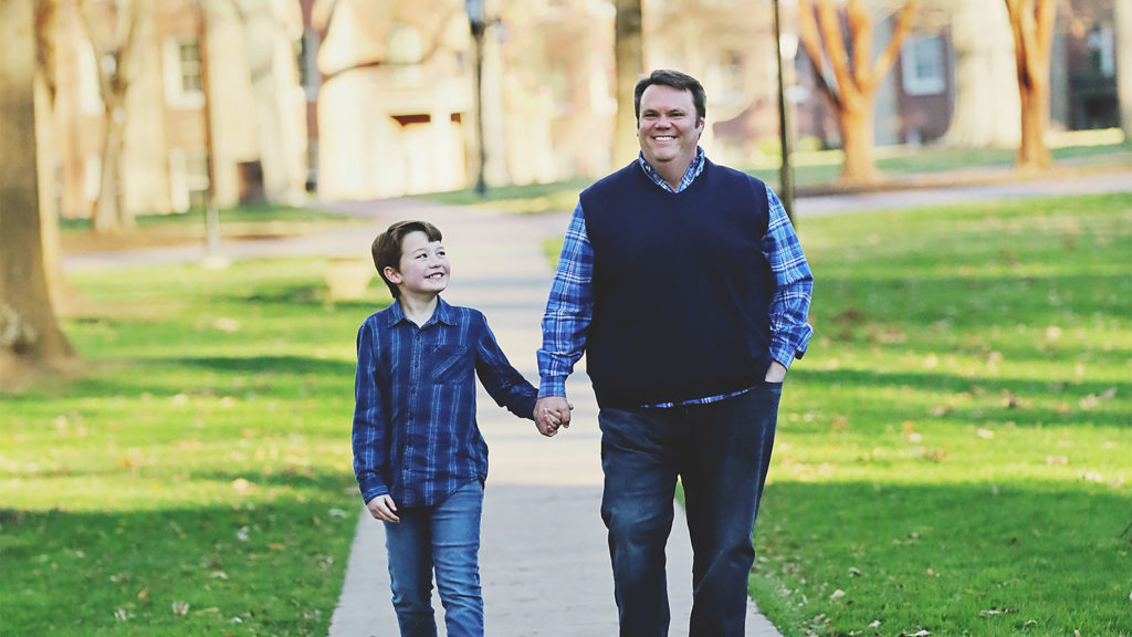 Cecil and Boone Stokes walk down the sidewalk together.