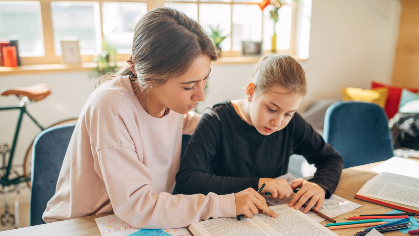 Two foster siblings read together.