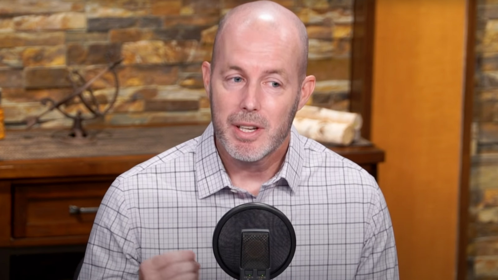 Jason Johnson speaks into a microphone sharing stories from his own foster parenting journey.