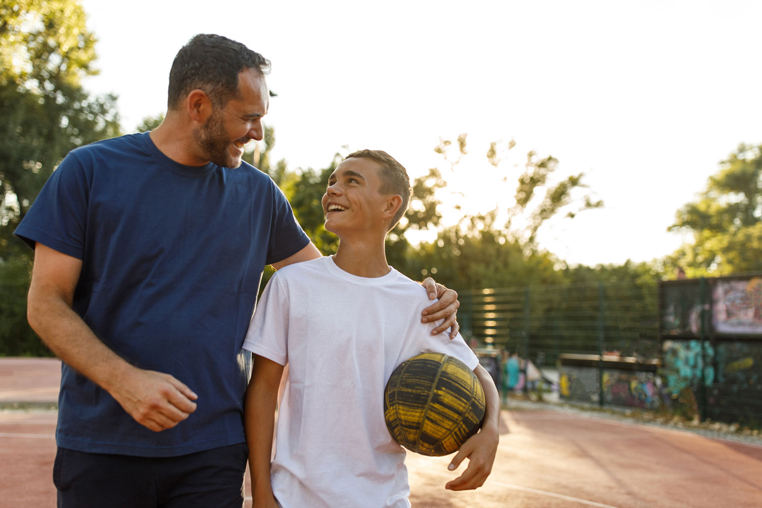 Father and son play basketball