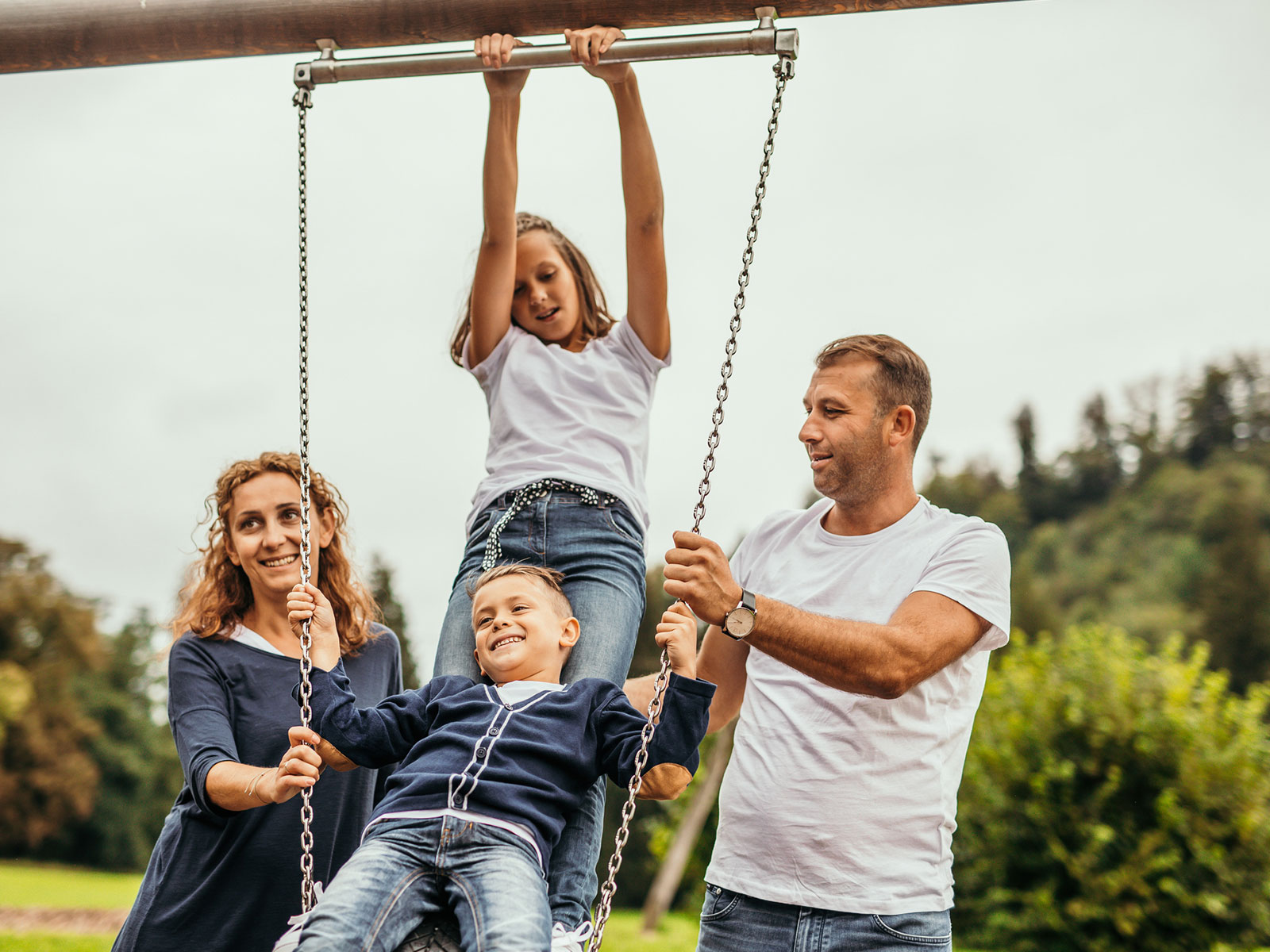 Family plays together at a park.