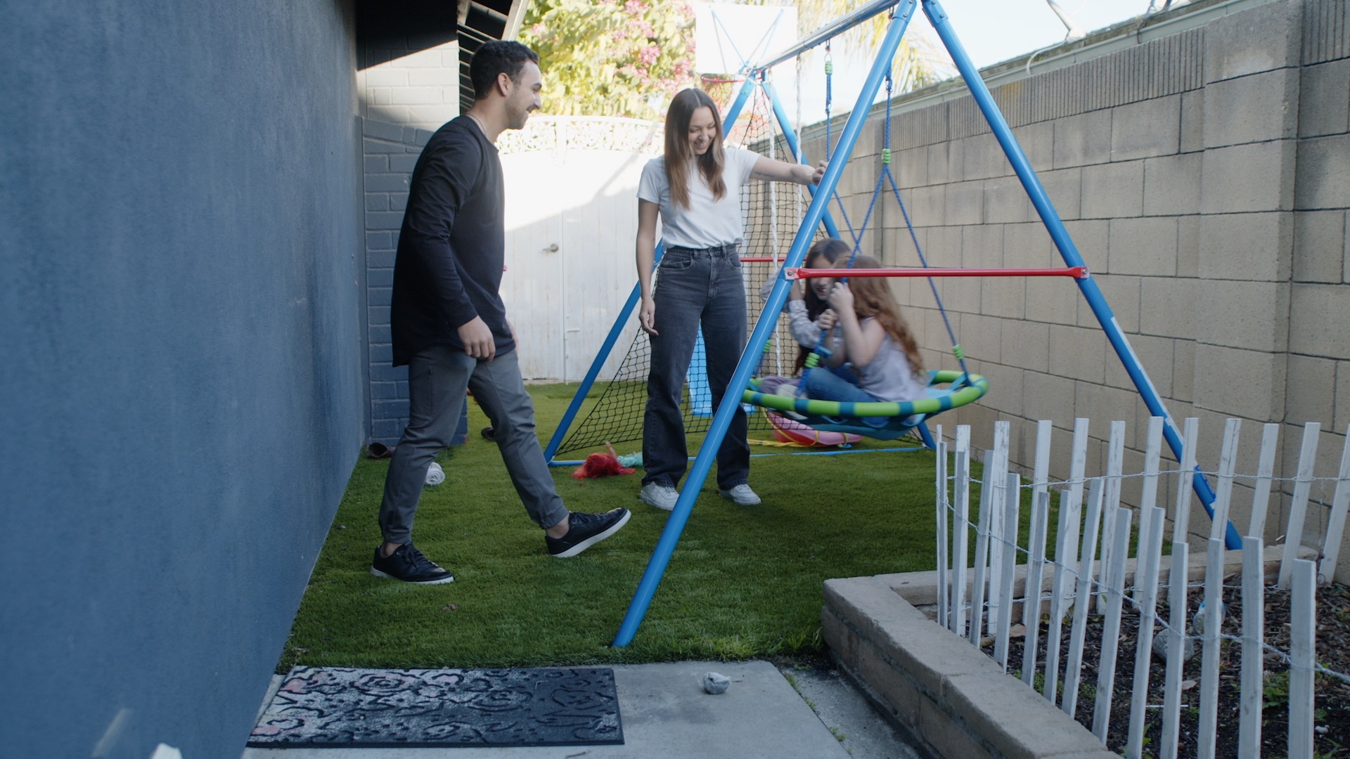 support foster family by playing with kids in backyard